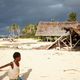 In this Saturday, May 30, 2015, photo, children play on the beach in the town of Takara, on Efate Island, Vanuatu. The town was damaged during Cyclone Pam.
